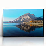 Large abstract wall art of Lake Como with muted blue and green tones, in a black acrylic frame.