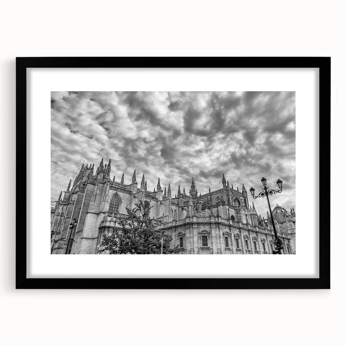 Colorful abstract art print of Andalusian scenery in vibrant hues on a large textured canvas, framed in black.