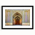 Colorful abstract art print of a Middle Eastern scenery in muted orange and blue tones on a large framed canvas.