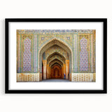 Colorful abstract art print of a Middle Eastern scenery in muted orange and blue tones on a large framed canvas.