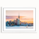 Abstract art print of Auckland skyline in muted blue and gray tones on a white-framed canvas, ideal for dining room decor.