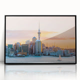 Large abstract wall art depicting Auckland's skyline in muted gray and blue tones, framed in black acrylic.