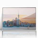 Acrylic print of Auckland skyline in muted gray and blue tones, framed in white, suitable for modern art wall decor.