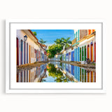 Abstract art print of a stylized Brazilian landscape in vibrant green and blue tones, framed with a white mat.