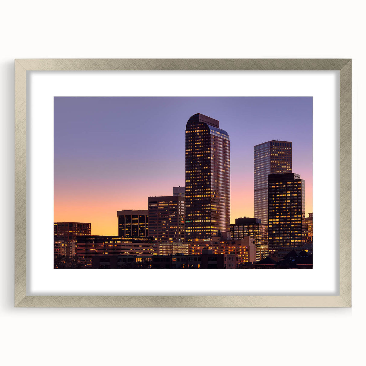 Textured abstract art print of Denver skyline in muted earth tones, framed in silver, ideal for bedroom decor.