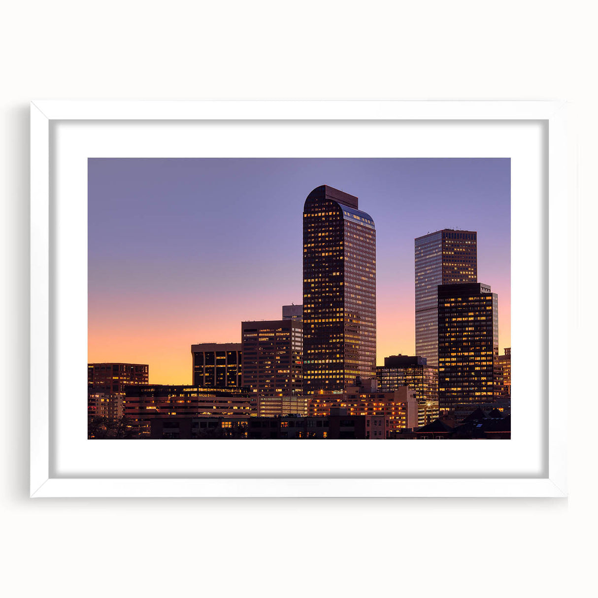 Abstract art print of Denver skyline in muted gray and blue tones on a framed white mat, ideal for dining room decor.