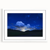 Abstract art print of Colorado Springs in muted green and blue tones on a framed white mat, suitable for dining room decor.