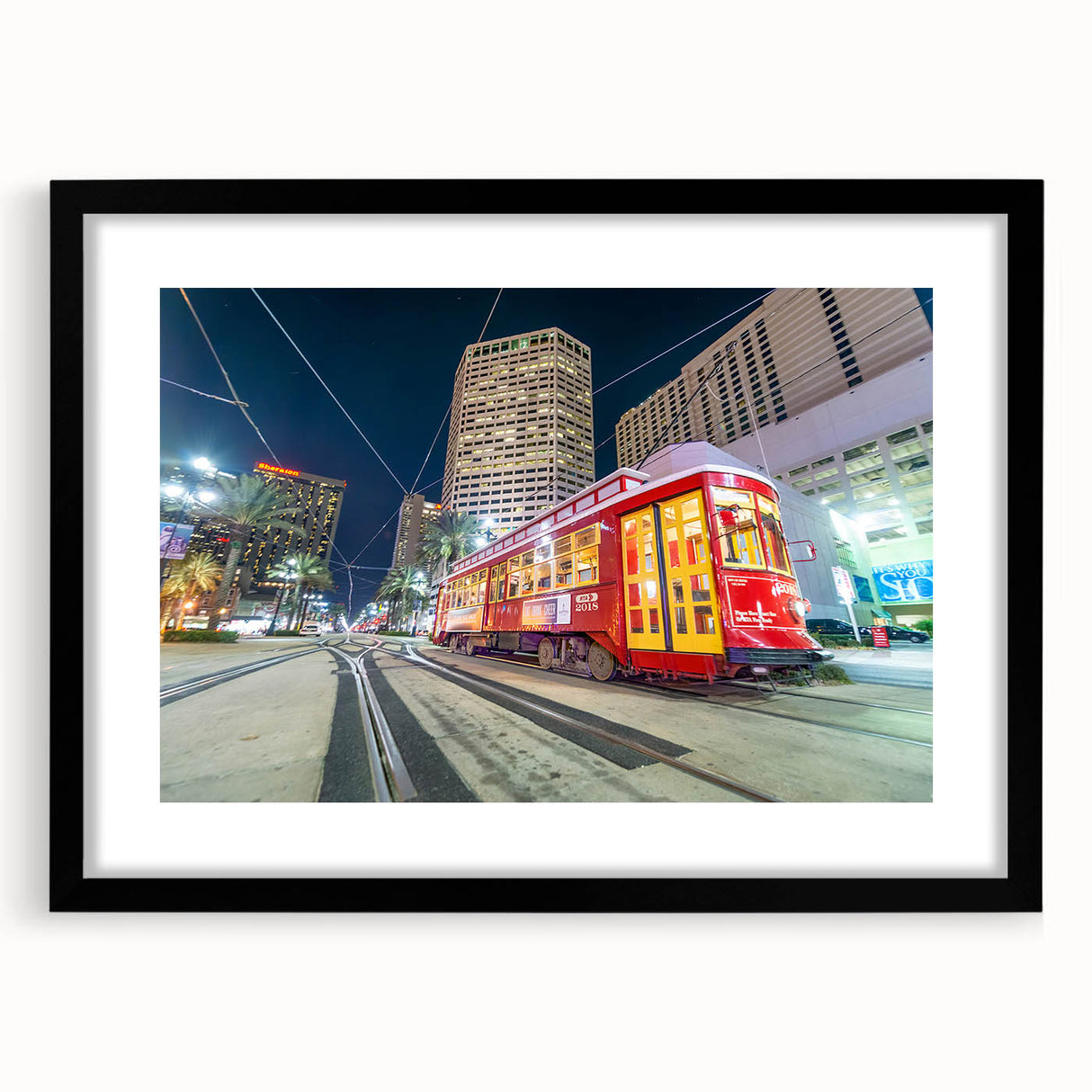 Colorful abstract art print of New Orleans scenery in vibrant hues on a large framed canvas, ideal for living room decor.