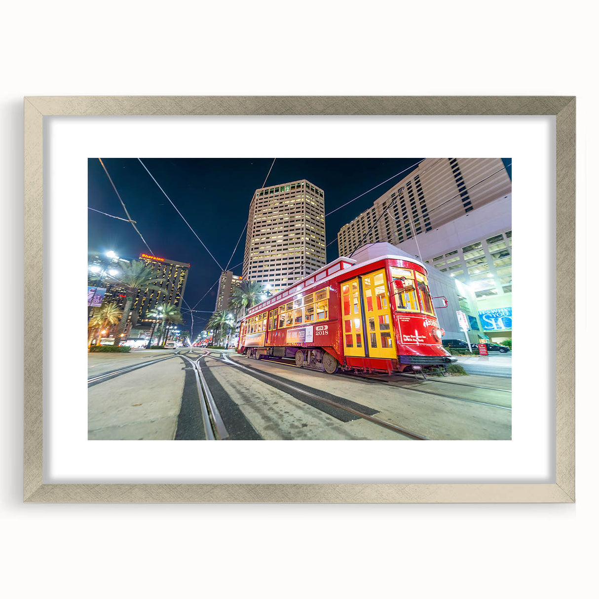 Textured abstract art print of New Orleans scenery in muted blue and gray tones, framed with silver mat.
