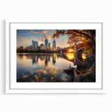 Abstract art print of Minneapolis skyline in muted gray and blue tones, framed with a white mat.