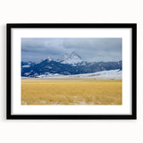 Abstract art print featuring textured, colorful scenery of Montana, in a large black frame with mat.