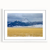 Abstract art print of Montana scenery in muted earth tones on a framed white mat, ideal for dining room decor.
