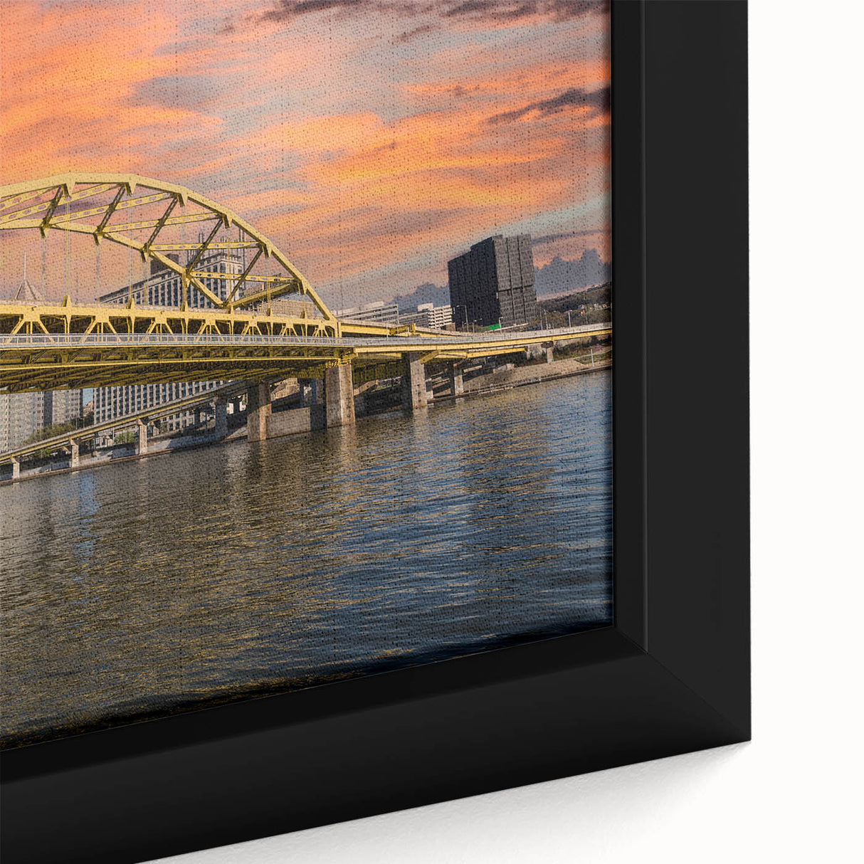 Close-up of textured black wall art depicting Pittsburgh skyline with colorful accents on a framed canvas.