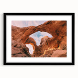 Extra large abstract art print of Arches National Park in vibrant, colorful hues on a textured canvas, framed in black.