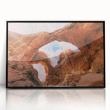 Large abstract wall art depicting Arches National Park in muted earth tones on a black framed acrylic.