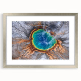 Textured art depicting an abstract scene of Yellowstone with muted earth tones, framed in silver.