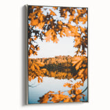 Framed canvas depicting a vintage landscape art painting of a fall scene with colorful foliage and a black border.