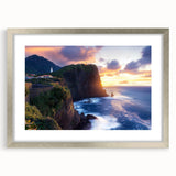 Silver-framed landscape artwork showcasing dramatic cliffs and a serene sky, presented with a white mat for an elegant display in home decor settings.