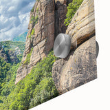 Close-up view of a vibrant acrylic artwork depicting dramatic cliffs and landscapes, showcasing intricate details and rich colors, perfect for modern home decor.