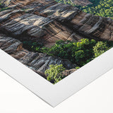 Vibrant rolled canvas depicting dramatic cliffs against a serene sky, showcasing intricate textures and colors, perfect for home decor or art lovers.