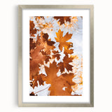 Textured abstract art print depicting autumn hues on a framed silver canvas, suitable for bedroom art.