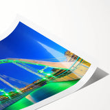 Rolled print showcasing a vibrant landscape bridge design, featuring rich colors and intricate details, securely packaged in a protective cardboard tube for easy transport.