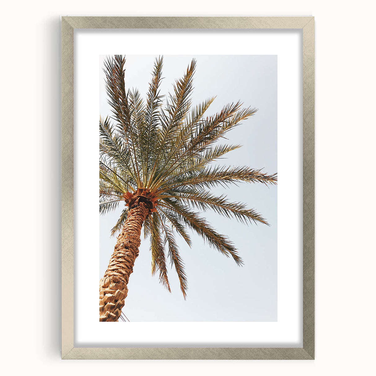 Textured abstract art print in warm orange and yellow hues on a silver-framed canvas, ideal for bedroom ambiance.