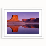 Framed landscape artwork depicting rugged cliffs under a bright blue sky, with a white mat enhancing its elegance, perfect for home decor.