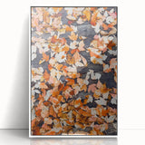 Art deco poster of an abstract fall landscape in warm orange and brown hues, acrylic print framed in white.