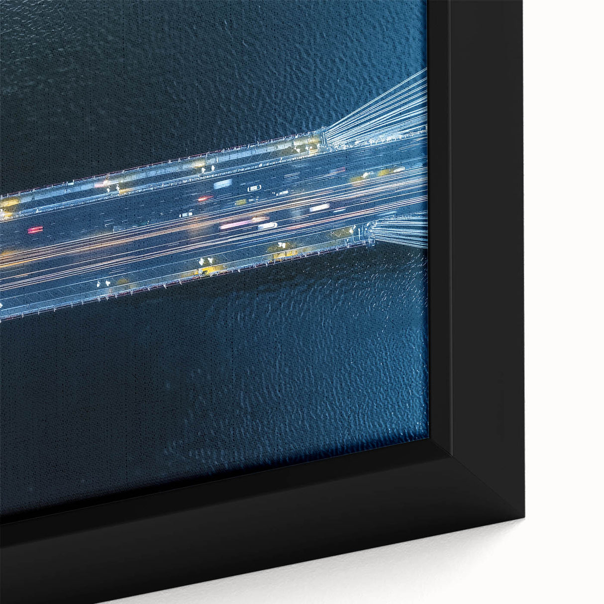 Close-up of a framed canvas print depicting a serene landscape with a bridge, showcasing vibrant colors and intricate details, ideal for home decor enhancement.