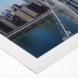 Rolled canvas artwork showcasing a serene landscape bridge scene with vibrant colors and intricate details, ideal for home decor, packaged securely in a protective tube.