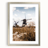 Textured abstract art print in warm orange and red tones on a silver-framed canvas, ideal for bedroom decor.