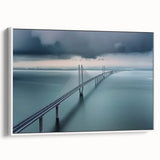 Framed canvas art depicting a serene landscape bridge scene in soft hues of blue and green, showcasing nature's tranquility with a white frame accentuating the artwork.