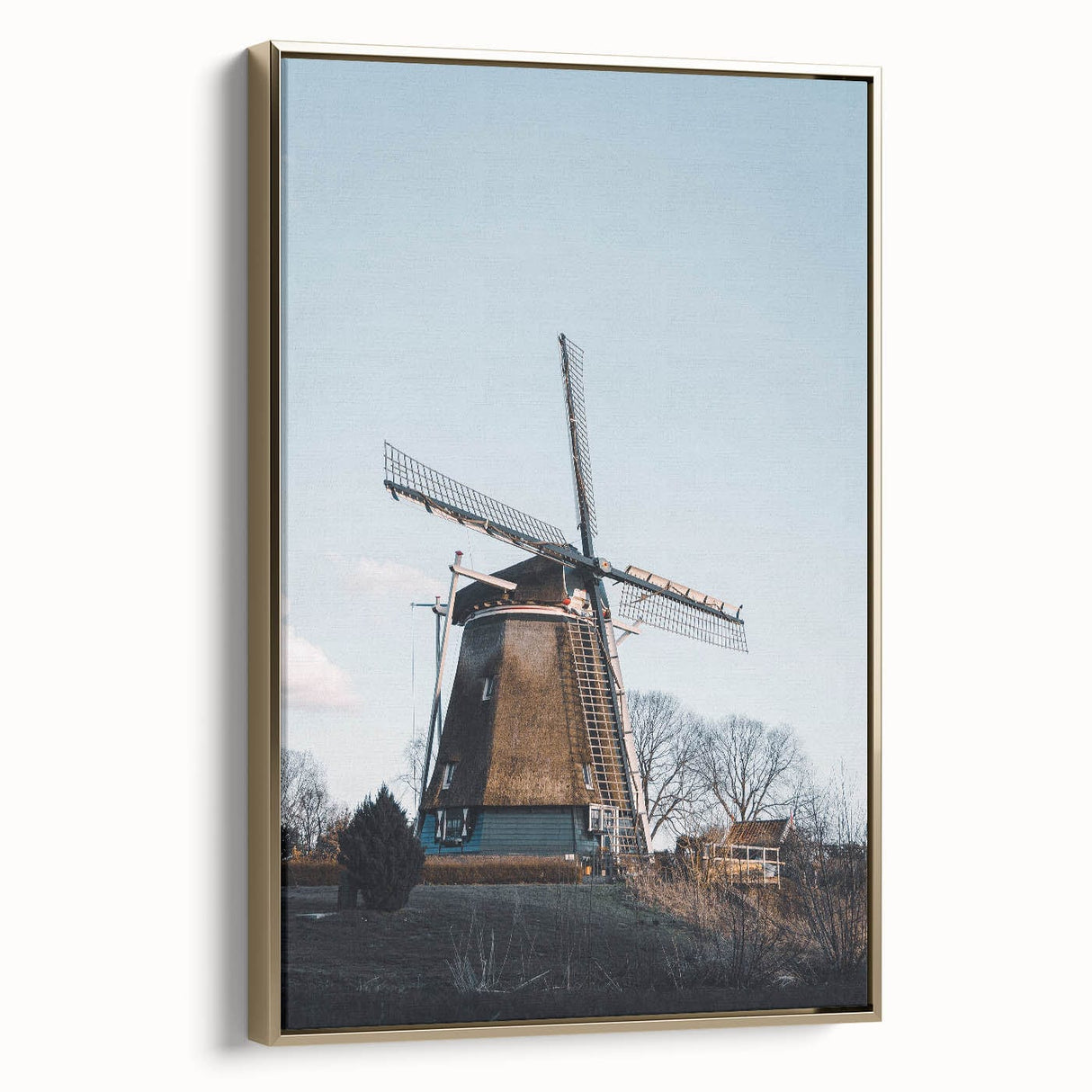 Framed canvas featuring a vintage landscape painting of an autumnal forest with muted gold and black tones.