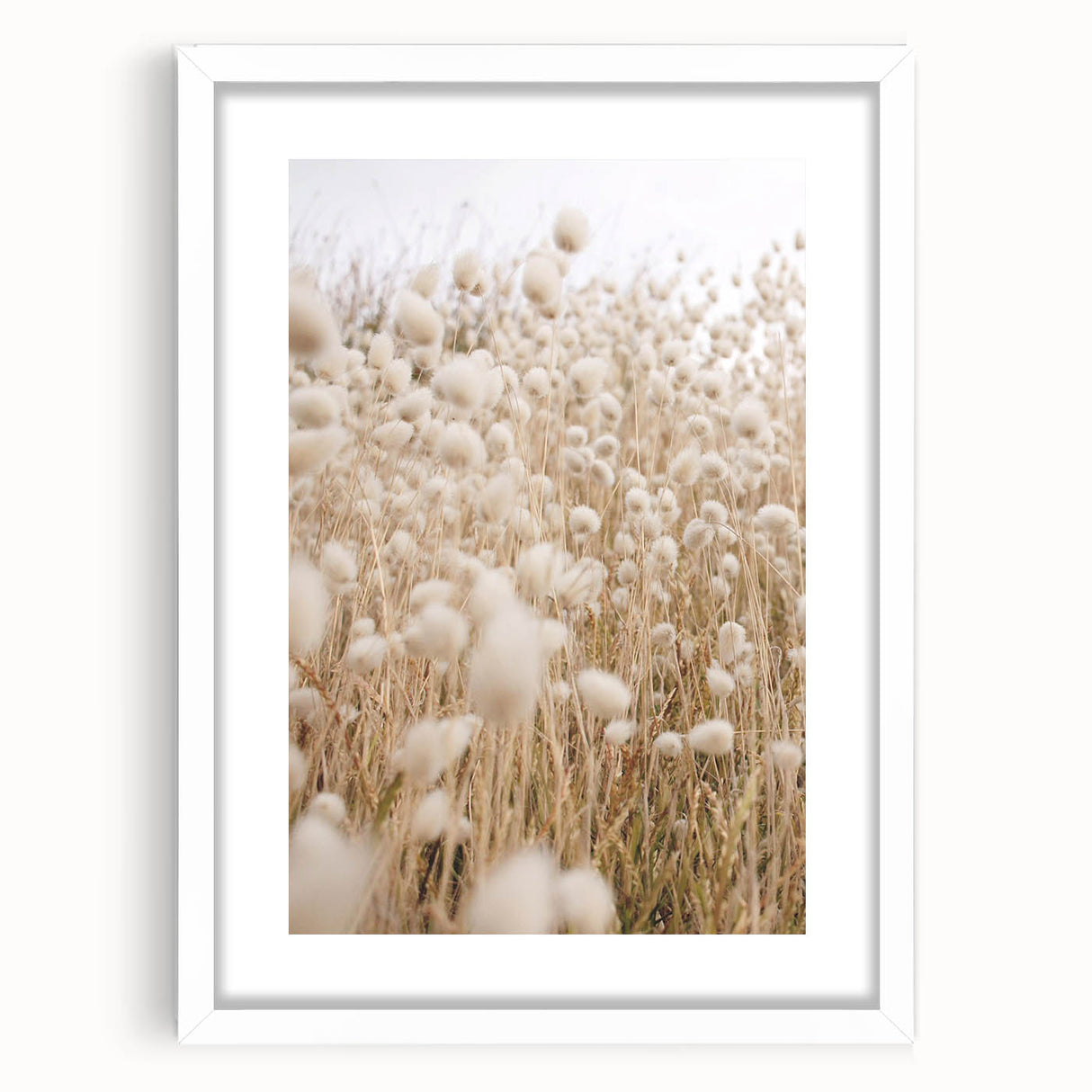 Abstract art print featuring vibrant summer motifs in orange and yellow on a white framed canvas.