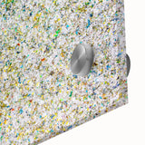 Close-up of vibrant acrylic splatter artwork on glass, showcasing a dynamic blend of colors including blue, yellow, and red, perfect for modern decor or art enthusiasts.