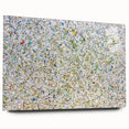 Abstract acrylic art print showcasing vibrant splatters in bold colors, displayed in a sleek glass frame with pins for mounting. Ideal for modern home decor.