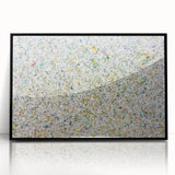 Framed acrylic artwork showcasing vibrant abstract splatters in black and multicolored hues, ideal for modern home decor, enhancing contemporary aesthetics.
