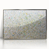 Framed acrylic artwork featuring abstract splatters in silver tones, set against a modern backdrop, perfect for contemporary home decor. Ideal for adding a splash of artistic flair to living spaces or offices.