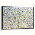 Framed canvas artwork showcasing abstract splatter designs in vibrant colors, viewed from the side against a black background, ideal for modern home decor.