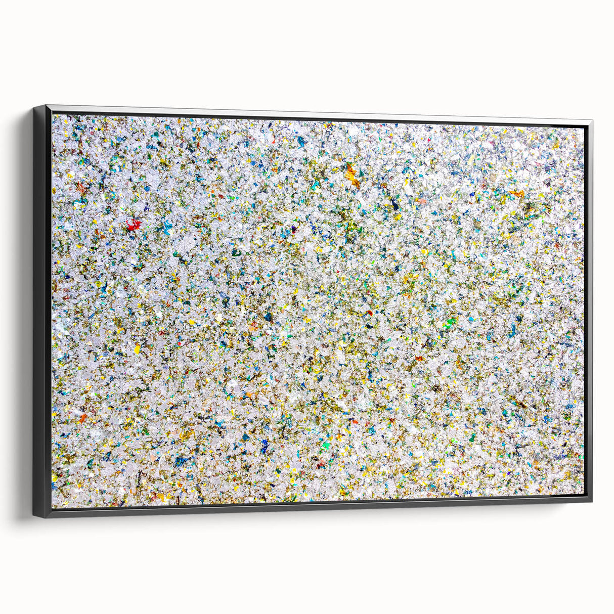 Framed canvas artwork showcasing abstract splatter designs in vibrant colors, viewed from the side against a black background, ideal for modern home decor.