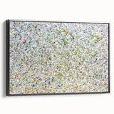 Framed canvas artwork showcasing abstract splatter designs in vibrant colors, viewed from the side against a black background, ideal for modern home decor.