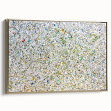 Framed canvas artwork showcasing abstract gold splatters on a textured background, presented in a stylish side view, perfect for modern home decor.