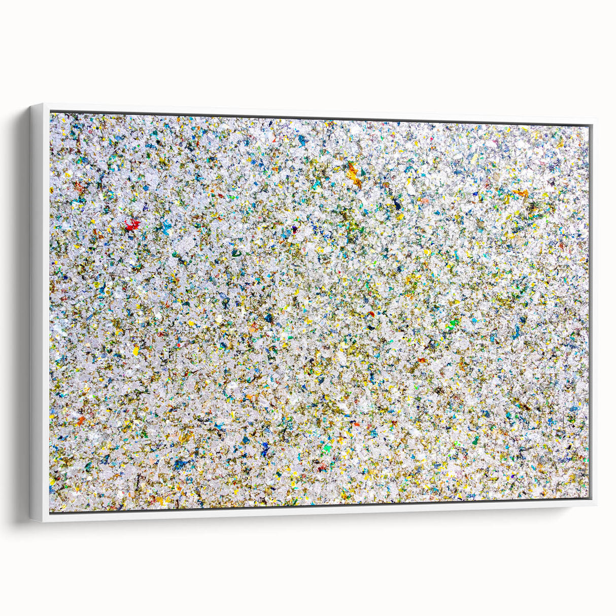 Framed abstract art canvas showcasing colorful splatters against a white background, presented in a stylish side view, perfect for modern home decor.