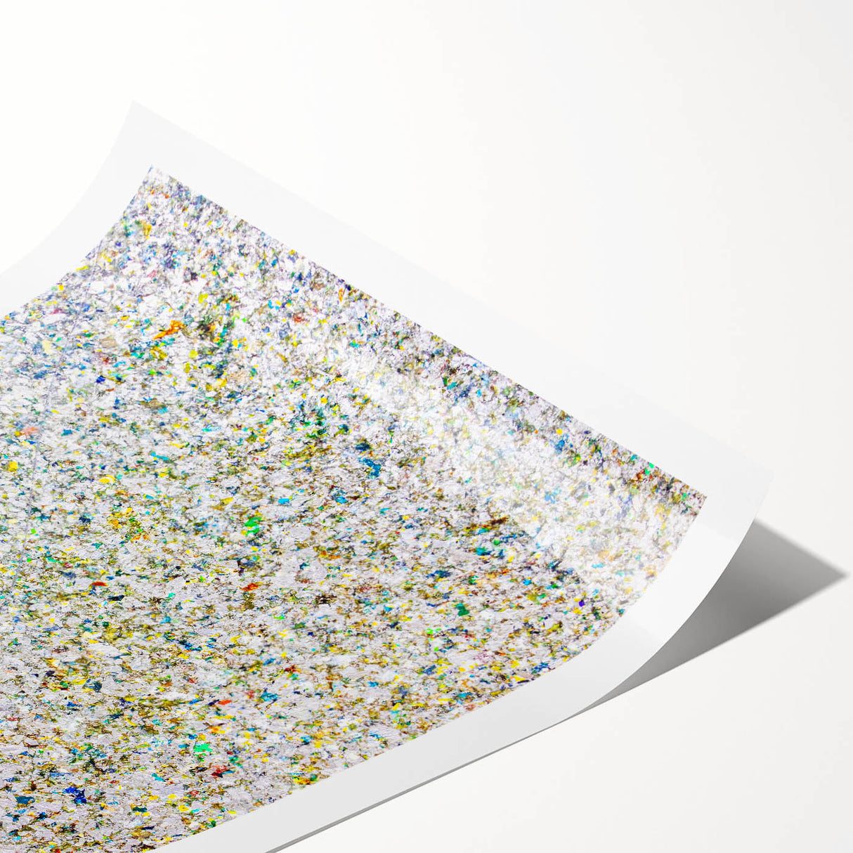 Abstract splatter art print on textured paper showcasing vibrant colors of blue, yellow, and pink, rolled securely in a protective cardboard tube for easy display.