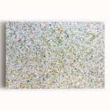 Abstract splatter art on a stretched canvas, showcasing vibrant colors of blue, yellow, and red, perfect for modern home decor and artistic expression.