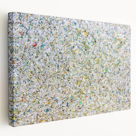 Abstract splatter art on stretched canvas showcasing vibrant colors of blue, yellow, and red, ideal for modern home decor. Perfect for enhancing artistic spaces.