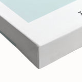 Large art of a black and white landscape painting on stretched canvas, featuring a series of food dishes.