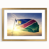 Abstract art print of an African landscape in gold frame, featuring earthy tones, ideal for dining room decor.