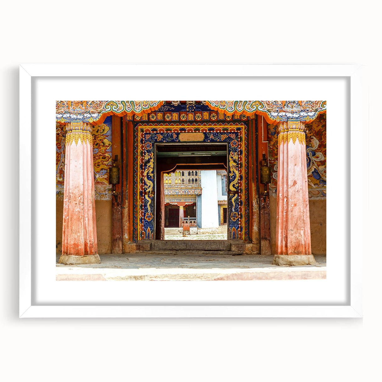 Abstract art print of Bhutanese scenery in muted earth tones on a framed white mat, ideal for dining room decor.